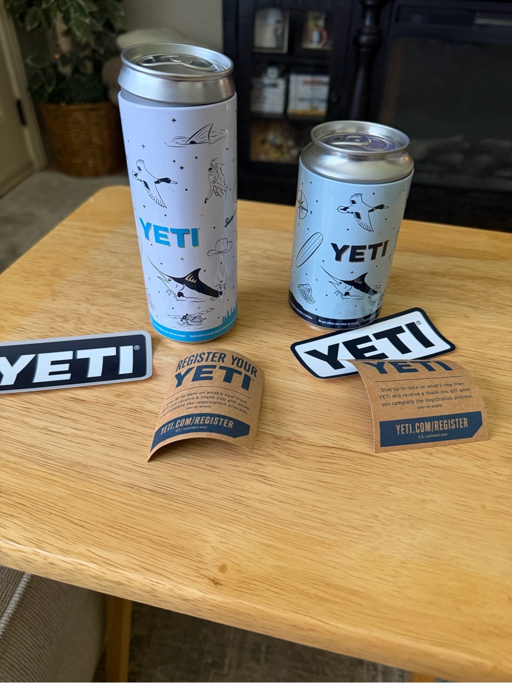 Yeti Slim Can Coolers in Light Gray with Blue Logo Accents